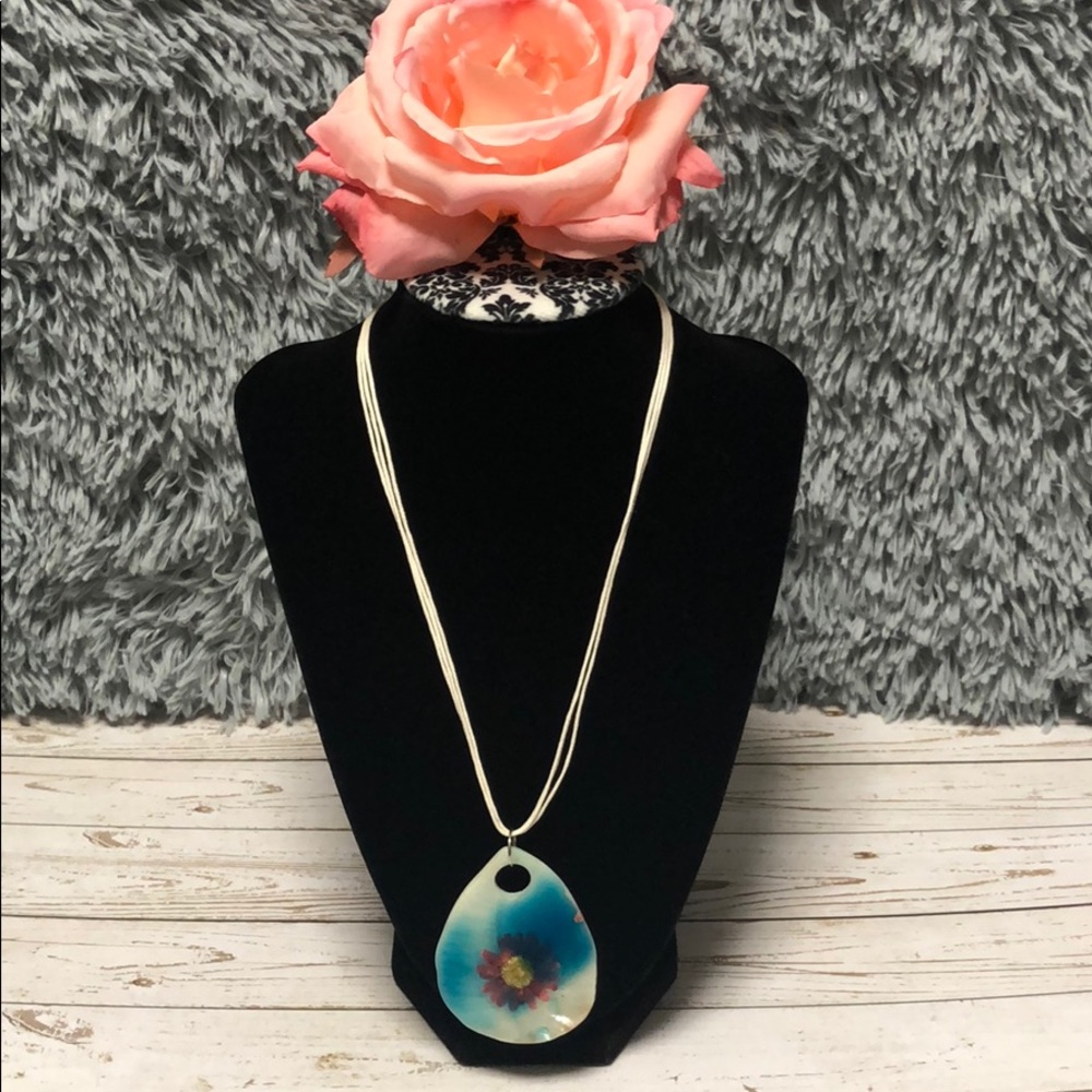 Real flower necklace encased in a seashell
